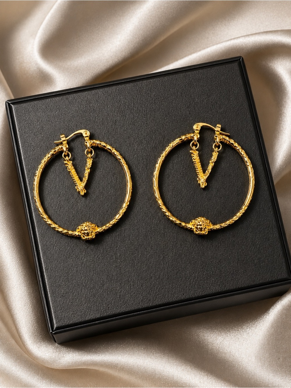 Gold Textured Medusa Hoop Earrings with V-Knot Accent